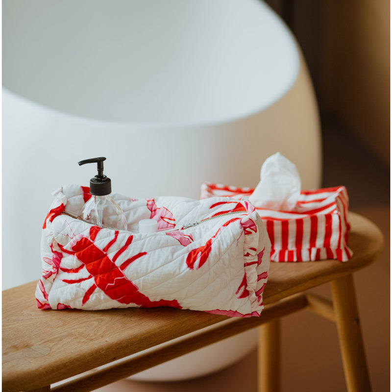 Lobster make-up bag and red and white tissue box in a bathroom