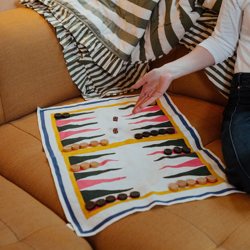 Gammon tea towel game being used with gammon pieces