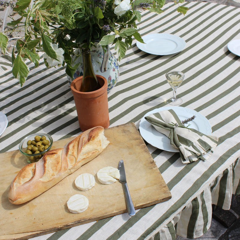 Amuse La Bouche green striped table linen on a hosting table set up 