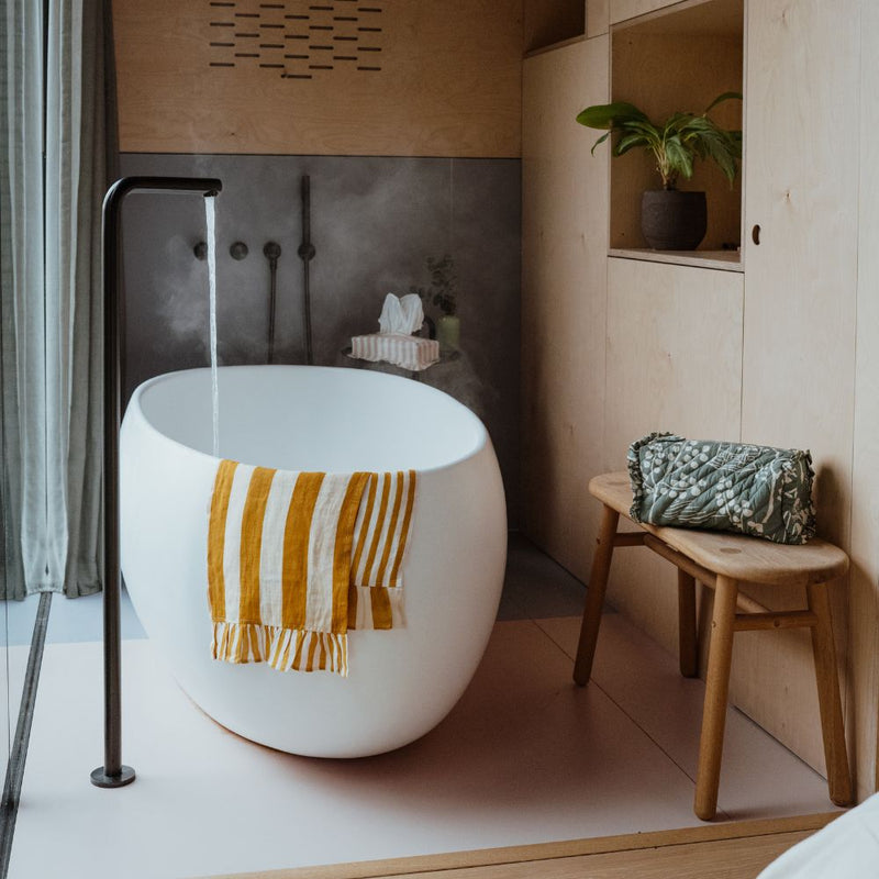 Steamy bath and bathroom with striped accessories by Amuse La Bouche